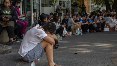 People wait in the open following an earthquake in Bangkok, Thailand, Friday, March 28, 2025. Myanmar was struck by its biggest earthquake in a century, shaking buildings and triggering evacuations in neighbouring Vietnam and Thailand. (Bloomberg) People wait in the open following an earthquake in Bangkok, Thailand, Friday, March 28, 2025. Myanmar was struck by its biggest earthquake in a century, shaking buildings and triggering evacuations in neighbouring Vietnam and Thailand. (Bloomberg)