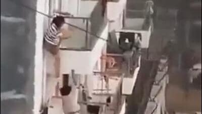 The fire spread swiftly through the building, and a dramatic video of two women at the PG accommodation scale down from their second-floor room emerged on social media. (HT Photo) The fire spread swiftly through the building, and a dramatic video of two women at the PG accommodation scale down from their second-floor room emerged on social media. (HT Photo)