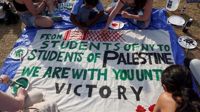 Students at Columbia University paint a response to a message written by Palestinians in Rafah thanking students for their support as they continue to maintain a protest encampment on campus in support of Palestinians, during the ongoing conflict between Israel and the Palestinian Islamist group Hamas, in New York City, U.S., April 28, 2024. (REUTERS FILE)