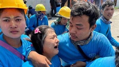 Workers react while sitting on ground after a strong earthquake struck central Myanmar on Friday. (AP photo)