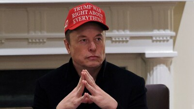 Tesla CEO Elon Musk wears a 'Trump Was Right About Everything!' hat while (REUTERS)