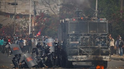 Riot police personnel take cover from stones hurled by pro-monarchist demonstrators during a protest demanding the restoration of Nepal's monarchy, which was abolished in 2008, saying the governments have failed to make any significant changes, in Kathmandu, Nepal, (Reuters) Riot police personnel take cover from stones hurled by pro-monarchist demonstrators during a protest demanding the restoration of Nepal's monarchy, which was abolished in 2008, saying the governments have failed to make any significant changes, in Kathmandu, Nepal, (Reuters)