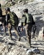 Security personnel patrol a remote forested area, in Kathua district, on Friday. (PTI)