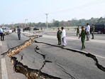 In this image provided by The Myanmar Military True News Information Team, Myanmar's military leader Senior Gen. Min Aung Hlaing, center, inspects damaged road caused by an earthquake Friday, in Naypyitaw.