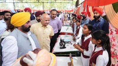 Punjab chief minister Bhagwant Mann listening to students as state AAP affairs in-charge Manish Sisodial looks on during their visit to the School of Eminence at Dhuri on Saturday. (X) Punjab chief minister Bhagwant Mann listening to students as state AAP affairs in-charge Manish Sisodial looks on during their visit to the School of Eminence at Dhuri on Saturday. (X)