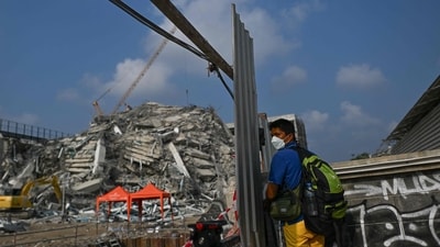 A man uses his smartphone to record at the site of an under-construction building collapse in Bangkok on March 29, 2025, a day after the earthquake struck central Myanmar and Thailand. (AFP) A man uses his smartphone to record at the site of an under-construction building collapse in Bangkok on March 29, 2025, a day after the earthquake struck central Myanmar and Thailand. (AFP)