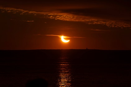A partial solar eclipse rises over the Atlantic Ocean in Halifax on Saturday. (AP)