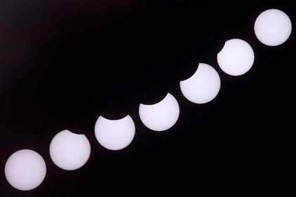 A composite image of 7 separate photographs taken with a single fixed camera shows the partial solar eclipse seen from Castillo del Romeral, on the island of Gran Canaria. Spain. (REUTERS)