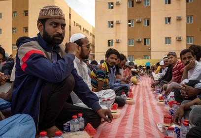 Muslim devotees gather to break their fast during a group iftar at a housing complex for foreign labourers in Dubai on March 28, 2025, during the Muslim holy fasting month of Ramadan. (Photo by FADEL SENNA / AFP) (AFP) Muslim devotees gather to break their fast during a group iftar at a housing complex for foreign labourers in Dubai on March 28, 2025, during the Muslim holy fasting month of Ramadan. (Photo by FADEL SENNA / AFP) (AFP)