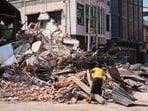 A women goes through rubble at a collapsed building following an earthquake in Naypyitaw, Myanmar Sunday, March 30, 2025. A women goes through rubble at a collapsed building following an earthquake in Naypyitaw, Myanmar Sunday, March 30, 2025.