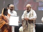 Union Home Minister Amit Shah along with Bihar Chief Minister Nitish Kumar presenting certificate to a farmer during state level cooperative conference at Bapu Auditorium, in Patna, Bihar.