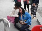 A woman reacts while waiting for news of missing loved ones at the site of an under-construction building collapse in Bangkok on March 30, 2025.