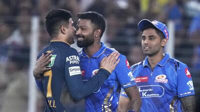Gujarat Titans' Shubman Gill (L) and Mumbai Indians' captain Hardik Pandya hug after Saturday’s match in Ahmedabad. (AP)