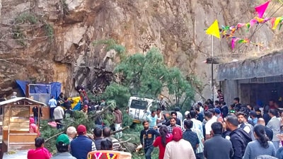 People gather near the site of accident after a tree fell on vehicles due to strong winds in Manikaran, in Kullu district, Himachal Pradesh. (PTI) People gather near the site of accident after a tree fell on vehicles due to strong winds in Manikaran, in Kullu district, Himachal Pradesh. (PTI)