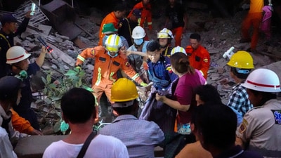 Rescue personnel carry a person out from the rubble of the building that collapsed following a strong earthquake, in Mandalay, Myanmar, on March 29, 2025. (REUTERS)
