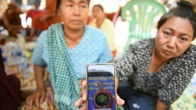A woman shows a picture of a missing monk during search and rescue operations at a damaged temple in Mandalay on March 30, 2025. (AFP) A woman shows a picture of a missing monk during search and rescue operations at a damaged temple in Mandalay on March 30, 2025. (AFP)