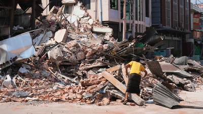 A women goes through rubble at a collapsed building following an earthquake in Naypyitaw, Myanmar Sunday, March 30, 2025. (AP) A women goes through rubble at a collapsed building following an earthquake in Naypyitaw, Myanmar Sunday, March 30, 2025. (AP)