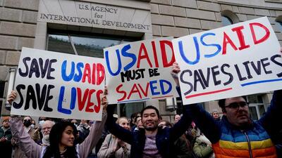 People protest as the USAID building sits closed to employees in Washington, DC, on February 3. (Reuters) People protest as the USAID building sits closed to employees in Washington, DC, on February 3. (Reuters)