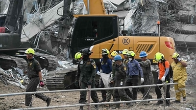 Rescue workers carry the body of a victim at the site of an under-construction building collapse in Bangkok on March 30, 2025. The United Nations has said that damaged critical infrastructure, including an airport, highways and bridges have slowed down the delivery of humanitarian aid. (AFP) Rescue workers carry the body of a victim at the site of an under-construction building collapse in Bangkok on March 30, 2025. The United Nations has said that damaged critical infrastructure, including an airport, highways and bridges have slowed down the delivery of humanitarian aid. (AFP)