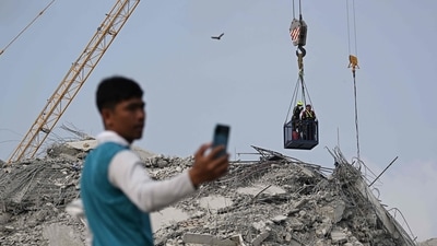 People wait for news of their missing loved ones as rescue workers descend towards the top of the rubble at the site of an under-construction building collapse in Bangkok on March 30, 2025. (AFP) People wait for news of their missing loved ones as rescue workers descend towards the top of the rubble at the site of an under-construction building collapse in Bangkok on March 30, 2025. (AFP)