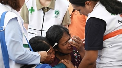 Women are comforted by health workers after hearing of the death of a relative at the site of an under-construction building collapse in Bangkok on March 30, 2025. Myanmar's neighbouring countries have rushed humanitarian aid and rescue personnel to help the civil war-torn nation. (AFP) Women are comforted by health workers after hearing of the death of a relative at the site of an under-construction building collapse in Bangkok on March 30, 2025. Myanmar's neighbouring countries have rushed humanitarian aid and rescue personnel to help the civil war-torn nation. (AFP)