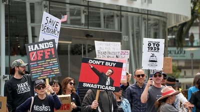 Anti-Musk protests outside Tesla dealerships across the US took place, with people trying to further drive down the automaker's declining sales. (AP) Anti-Musk protests outside Tesla dealerships across the US took place, with people trying to further drive down the automaker's declining sales. (AP)