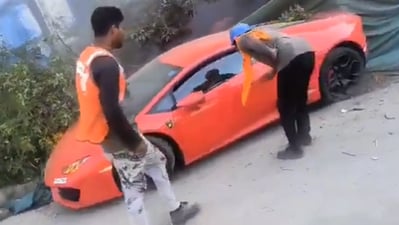 Labourers confront the driver of the Lamborghini luxury car that allegedly hit labourers in Noida Sector 94 area. (@SmritiSharma_/X) Labourers confront the driver of the Lamborghini luxury car that allegedly hit labourers in Noida Sector 94 area. (@SmritiSharma_/X)