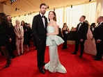 Emma Stone and Dave McCary pose on the red carpet during the Oscars arrivals at the 96th Academy Awards in Los Angeles. 