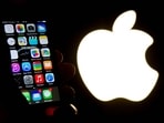 An illustration of an iPhone held up in front of the Apple Inc. logo taken of January 30, 2015 in Lille. Apple was fined �150 million on March 31, 2025 for abuse of a dominant position in the targeting of advertising on its devices, announced the French Competition Authority, while similar investigations are targeting the company in other European countries.