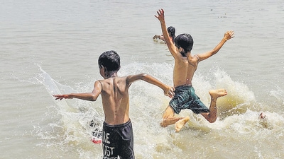 Children cool off in the Ganga river in Howrah on Sunday. (ANI)