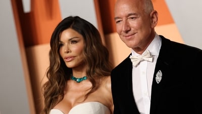 CEO of Amazon Jeff Bezos and partner Lauren Sanchez attend the Vanity Fair Oscar Party at the Wallis Annenberg Center for the Performing Arts in Beverly Hills, California, on March 2, 2025. (Photo by Michael Tran / AFP) (AFP) CEO of Amazon Jeff Bezos and partner Lauren Sanchez attend the Vanity Fair Oscar Party at the Wallis Annenberg Center for the Performing Arts in Beverly Hills, California, on March 2, 2025. (Photo by Michael Tran / AFP) (AFP)