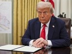 President Donald Trump listens to a question from a reporter before signing an executive order in the Oval Office of the White House in Washington. President Donald Trump listens to a question from a reporter before signing an executive order in the Oval Office of the White House in Washington.