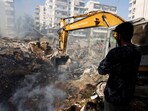 A man watches at the site of an Israeli strike, in Beirut southern suburbs, Lebanon.