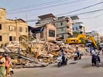 Mandalay: Commuters pass by the debris of damaged buildings in the aftermath of earthquake. Mandalay: Commuters pass by the debris of damaged buildings in the aftermath of earthquake.