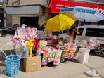 A Palestinian man stands near a stall selling toys, as Palestinians prepare for Eid al-Fitr marking the end of the Muslim holy month of Ramadan, in Jenin in the Israeli-occupied West Bank