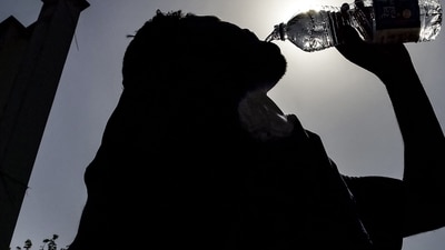 A passenger drinking water is silhouetted against the sun on a hot summer day at Jalandhar Cantonment railway station in Jalandhar on June 11, 2024 amid heatwave. India's heatwave is the longest ever to hit the country, the government's top weather expert said on June 10 as he warned people will face increasingly oppressive temperatures. Parts of northern India have been gripped by a heatwave since mid-May, with temperatures soaring over 45 degrees Celsius (113 degrees Fahrenheit). (Photo by Shammi MEHRA / AFP) (AFP) A passenger drinking water is silhouetted against the sun on a hot summer day at Jalandhar Cantonment railway station in Jalandhar on June 11, 2024 amid heatwave. India's heatwave is the longest ever to hit the country, the government's top weather expert said on June 10 as he warned people will face increasingly oppressive temperatures. Parts of northern India have been gripped by a heatwave since mid-May, with temperatures soaring over 45 degrees Celsius (113 degrees Fahrenheit). (Photo by Shammi MEHRA / AFP) (AFP)
