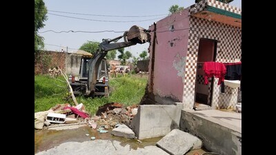 In a joint drive, the Kapurthala civil and police administration demolished three illegal structures owned by drug smugglers in Boot village of the district on Tuesday. (HT Photo)