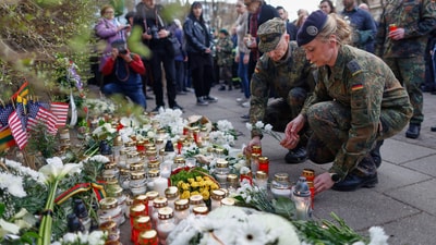 People light candles and pay respects to the four US soldiers who died after going missing in Lithuania (AP) People light candles and pay respects to the four US soldiers who died after going missing in Lithuania (AP)