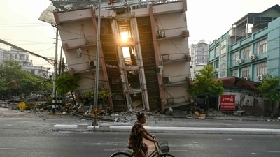 A woman rides her bicycle past a collapsed building in Mandalay on April 1, 2025, a few days after the deadly Myanmar earthquake. After a night sprawled out on cardboard panels under hastily erected plastic tarps, hundreds of Mandalay residents arose to another day of earthquake recovery, wondering when they can return safely to permanent shelter. (AFP) A woman rides her bicycle past a collapsed building in Mandalay on April 1, 2025, a few days after the deadly Myanmar earthquake. After a night sprawled out on cardboard panels under hastily erected plastic tarps, hundreds of Mandalay residents arose to another day of earthquake recovery, wondering when they can return safely to permanent shelter. (AFP)