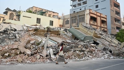 A woman walks past destroyed buildings in Mandalay on April 1, 2025, four days after a major earthquake struck central Myanmar. (AFP) A woman walks past destroyed buildings in Mandalay on April 1, 2025, four days after a major earthquake struck central Myanmar. (AFP)
