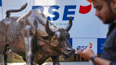A man walks past the bull statue at BSE building in Mumbai. (PTI) A man walks past the bull statue at BSE building in Mumbai. (PTI)
