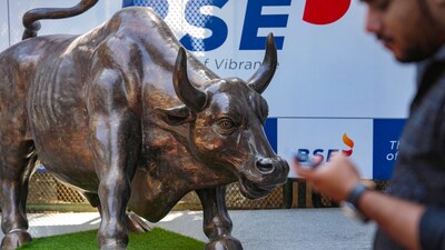 Sensex, Nifty 50 today: A man walks past the bull statue at BSE building in Mumbai. (PTI) Sensex, Nifty 50 today: A man walks past the bull statue at BSE building in Mumbai. (PTI)