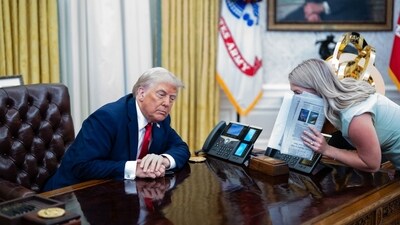 US President Donald Trump, left, and Karoline Leavitt, White House press secretary, speak during an executive order signing in the Oval Office of the White House in Washington, DC, US, on Monday, March 31, 2025. (Bloomberg) US President Donald Trump, left, and Karoline Leavitt, White House press secretary, speak during an executive order signing in the Oval Office of the White House in Washington, DC, US, on Monday, March 31, 2025. (Bloomberg)