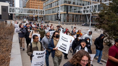 News of the student's arrest sparked protests, with members of the Graduate Labor Union-United Electrical, Radio and Machine Workers of America marching through downtown Minneapolis. (Reuters)