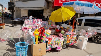 A Palestinian man stands near a stall selling toys, as Palestinians prepare for Eid al-Fitr marking the end of the Muslim holy month of Ramadan, in Jenin in the Israeli-occupied West Bank (REUTERS)
