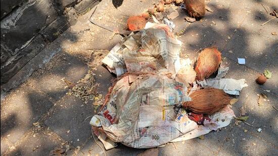 A bunch of lemons, coconut, sindoor and black voodoo dolls , wrapped in newspapers, was kept near the signboard of the Bombay High Court