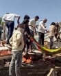 Rescuers at the scene of the fire on Tuesday. (ANI)