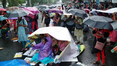Accredited Social Health Activist (ASHA) workers block a road during a protest for hike in their honorarium amid rains rain, in Thiruvananthapuram. (PTI) Accredited Social Health Activist (ASHA) workers block a road during a protest for hike in their honorarium amid rains rain, in Thiruvananthapuram. (PTI)
