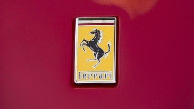 Ferrari has leased a 10,000 sq ft showroom space in North Bengaluru, near Kempegowda International Airport, at a monthly rent of  ₹8 lakh. (In photo: A Ferrari logo is seen on a Ferrari outside the New York Stock Exchange) (Representational photo) (Reuters)