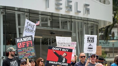 Anti-Musk protests outside Tesla dealerships across the US took place, with people trying to further drive down the automaker's declining sales. (AP) Anti-Musk protests outside Tesla dealerships across the US took place, with people trying to further drive down the automaker's declining sales. (AP)
